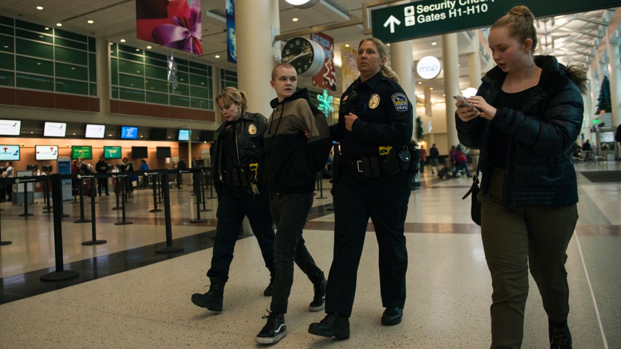 A woman is arrested at the Black Lives Matter protest at the airport Wednesday.