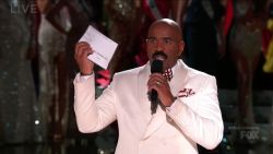Steve Harvey holds up the card with the name of the 2015 Miss Universe winner.