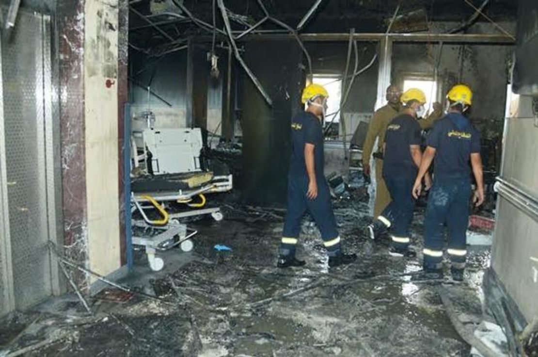 Firefighters search the hospital after the fire. 