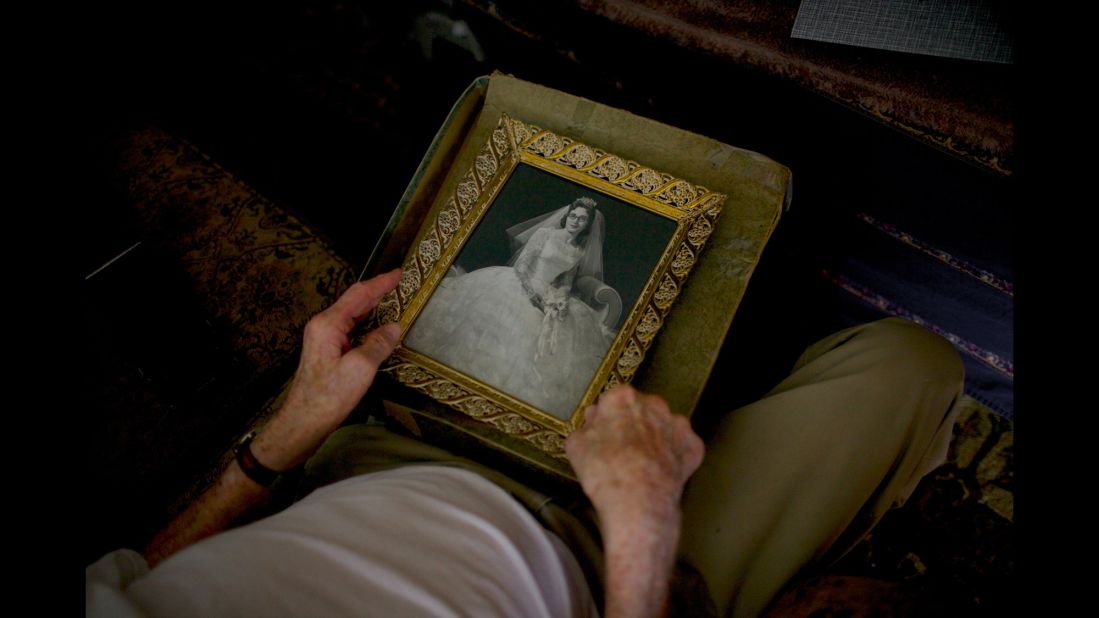 Frampton holds a photo of his wife, Theresa, in her wedding dress in 1956.