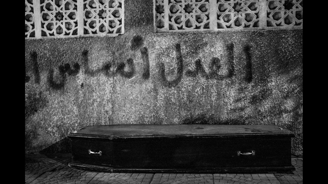 Graffiti behind this coffin says "Justice is the foundation of authority." This photo was taken in the Shobra neighborhood of Cairo.