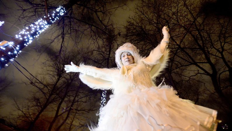 A  costumed woman joins a Christmas parade at Pushkinskaya Square in Moscow on Thursday.