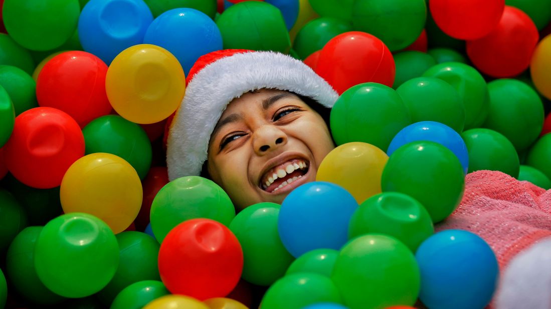 A girl plays in a plastic ball pit at a Christmas party in Dhaka, Bangladesh, on December 25.