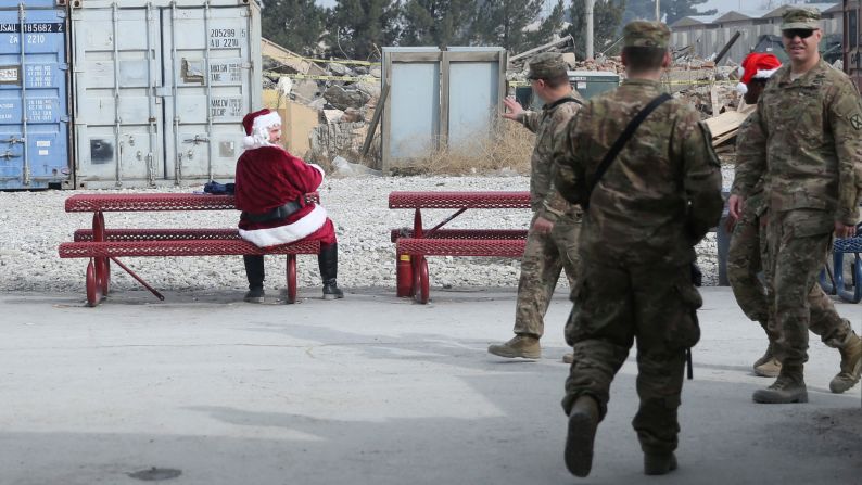 A U.S. soldier dressed as Santa Claus talks to fellow troops at Bagram Airfield north of Kabul, Afghanistan.