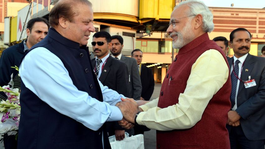Prime Minister of Pakistan Nawaz Sharif, left, shakes hands with Indian Prime Minister Narendra Modi at Allama Iqbal International Airport in Lahore, Pakistan, on Friday, December 25.
