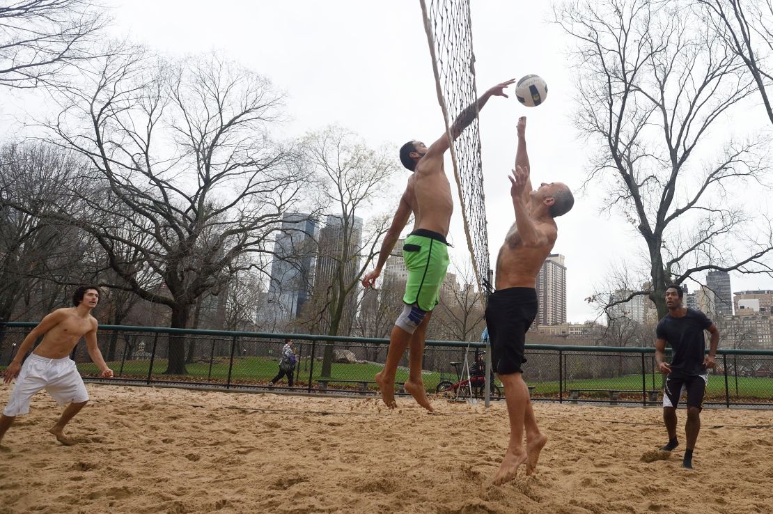 The shirts come off on Christmas Eve as a group plays volleyball in New York's Central Park. 