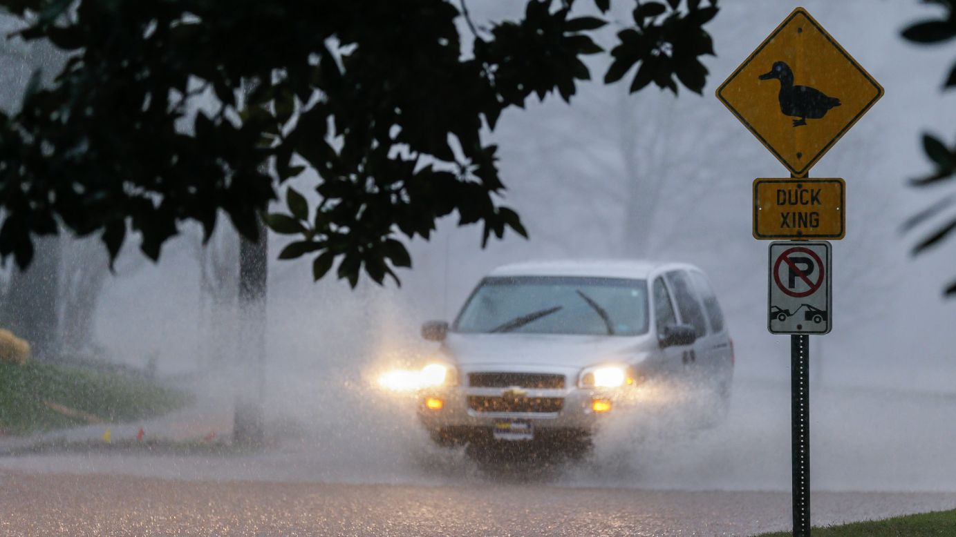 A vehicle drives through a flooded street as a record-breaking downpour continued in Avondale Estates, Georgia, on Thursday.
