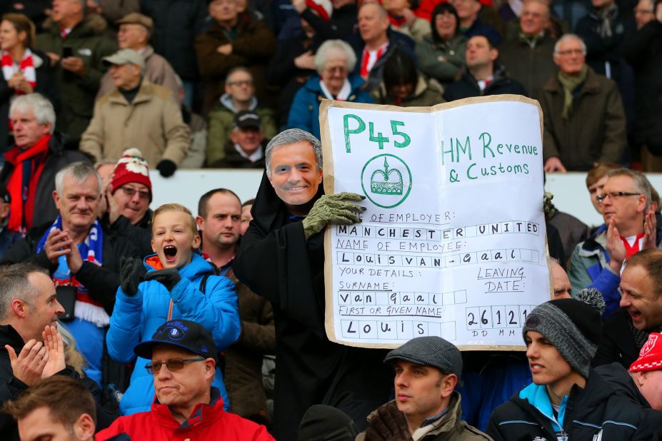A Stoke fan wears a Jose Mourinho mask and poses with a "P45" slip (which is handed to UK workers when they are fired from or leave a job) for Van Gaal, suggesting the Dutchman will be sacked by United and replaced by the former Chelsea boss.