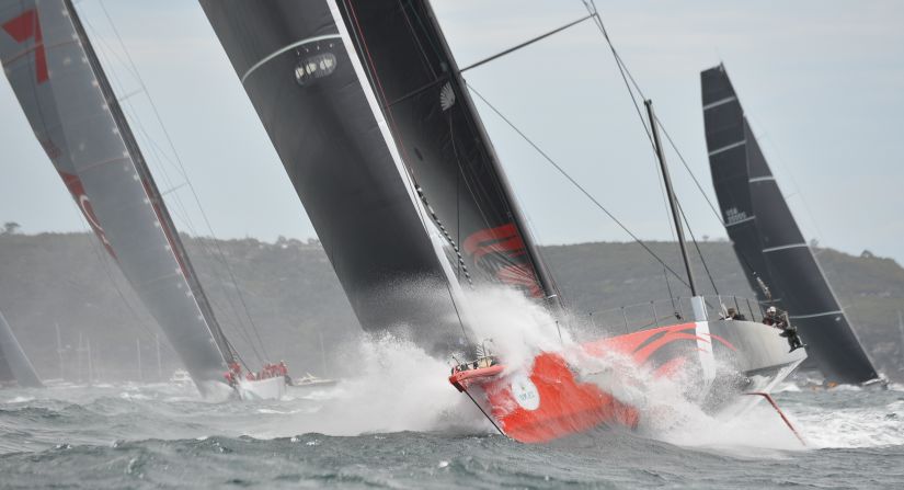 Here, supermaxi Comanche (center) leads Perpetual Loyal (right) and Wild Oats XI (left) at the start of the race coming out of Sydney Harbor on December 26, 2015.  