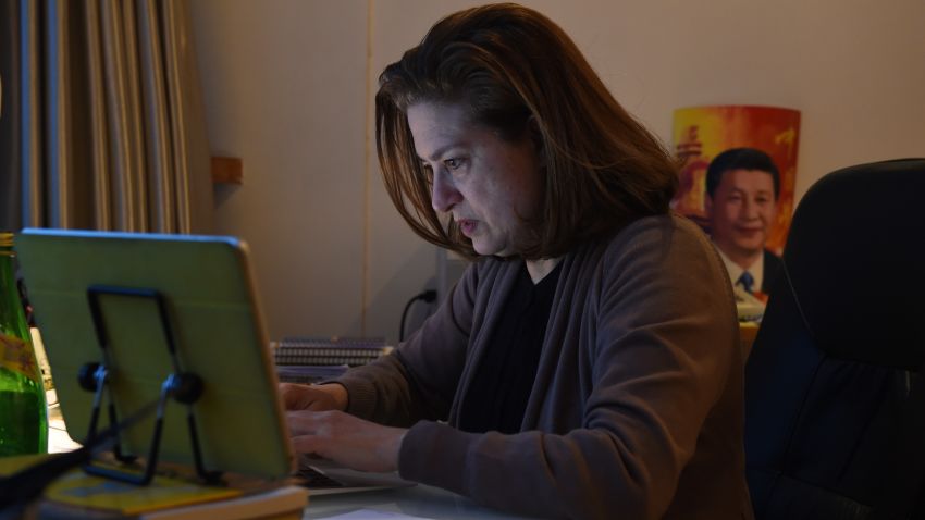 Ursula Gauthier works at her desk in her apartment in Beijing on December 26, 2015.