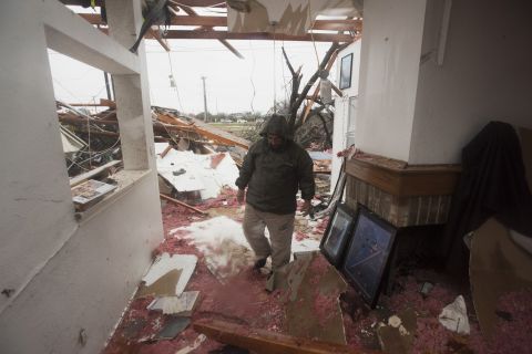 Bob Moore walks through his home in Rowlett the morning after it was hit by a tornado.