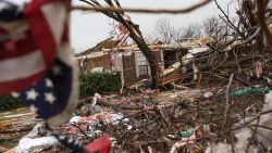 An American flag placed by first responders is seen December 27, 2015 in the aftermath of a tornado in Rowlett, Texas.  At least 11 people lost their lives as tornadoes tore through Texas, authorities said, as they searched home to home for possible more victims of the freak storms lashing the southern United States. The rare December twisters that flattened houses and caused chaos on highways raised the death toll from days of deadly weather across the South to at least 28. AFP PHOTO/LAURA BUCKMAN / AFP / LAURA BUCKMAN        (Photo credit should read LAURA BUCKMAN/AFP/Getty Images)