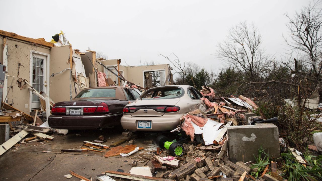 Debris is scattered around a driveway in Rowlett on December 27.