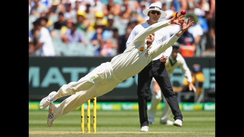 Australian cricketer Nathan Lyon dives for a catch during a Test match against the West Indies on Sunday, December 27.