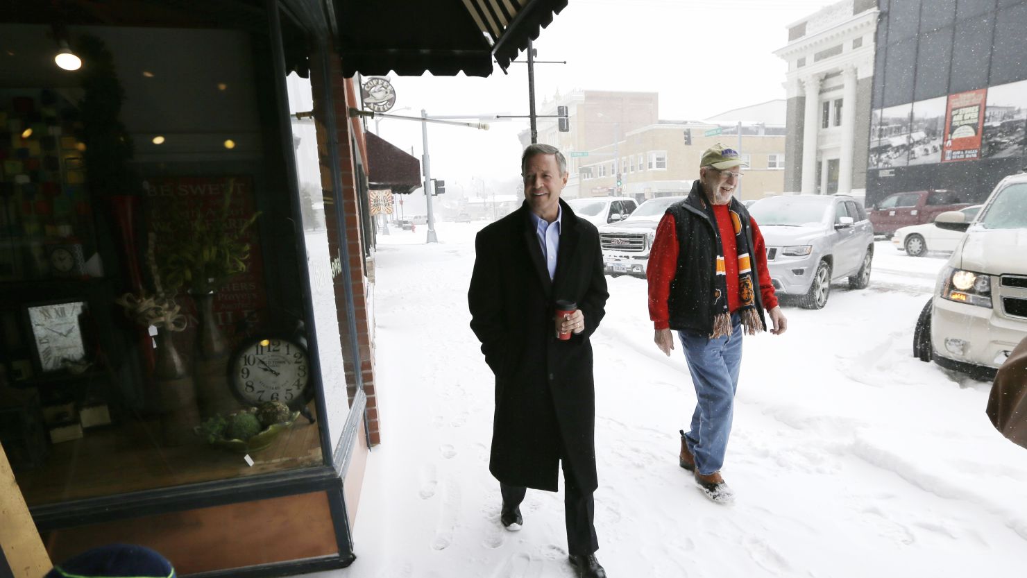 Democratic presidential candidate, former Maryland Gov. Martin O'Malley walks in the snow with Jerry Welden of Iowa Falls, Iowa, down main street in Iowa Falls, Iowa, Monday, Dec. 28, 2015, after speaking at the Hardin County New Leadership Forum. (AP Photo/Charlie Neibergall)