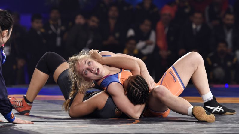 Oksana Herhel, top, wrestles Geeta Phogat during a wrestling match in New Delhi on Saturday, December 26. Herhel won the match, helping her team advance to the finals of the Pro Wrestling League.