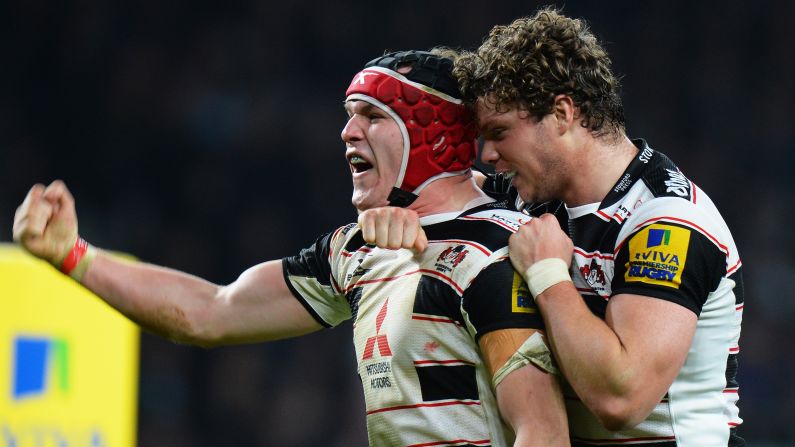 Gloucester's Rob Cook, left, celebrates Sunday, December 27, after scoring his team's fifth try during a Premiership match against Harlequins in London. The match ended in a 39-39 draw.