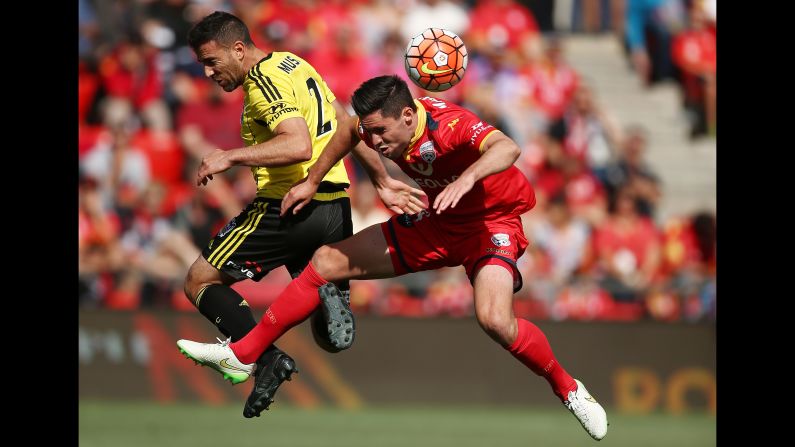 Adelaide United's Dylan McGowan, right, clears the ball in front of Wellington Phoenix's Manny Muscat during an A-League match in Adelaide, Australia, on Saturday, December 26.