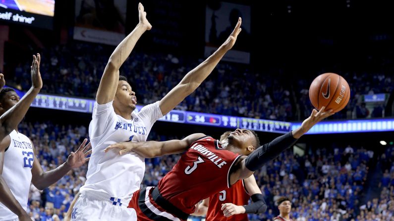Louisville guard Trey Lewis tries to shoot the ball over Kentucky's Skal Labissière on Saturday, December 26. Kentucky defeated its in-state rival 75-73.