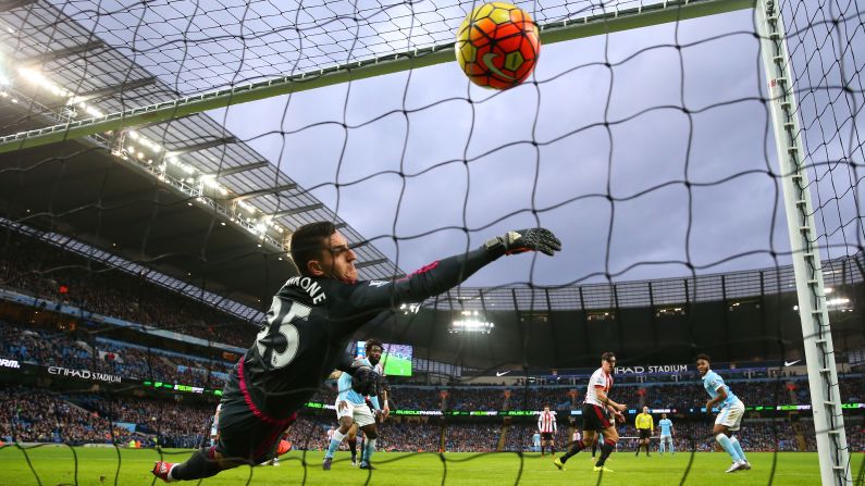 Sunderland goalkeeper Vito Mannone can't stop Manchester City's Raheem Sterling, right, from scoring the opening goal of a Premier League match Saturday, December 26, in Manchester, England. Manchester City went on to win 4-1.