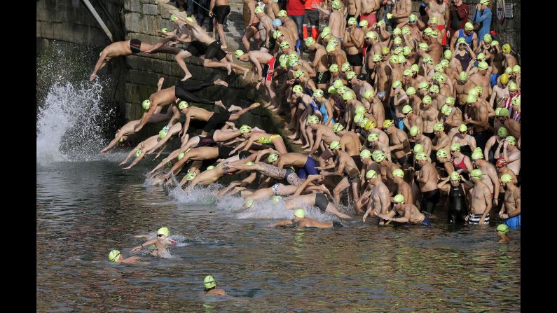 Swimmers jump into the water at the start of the Christmas Crossing in Gijon, Spain, on Friday, December 25. Every year, swimmers race at the city's port, covering 220 meters (722 feet) in what is Spain's second-oldest Christmas swimming competition.