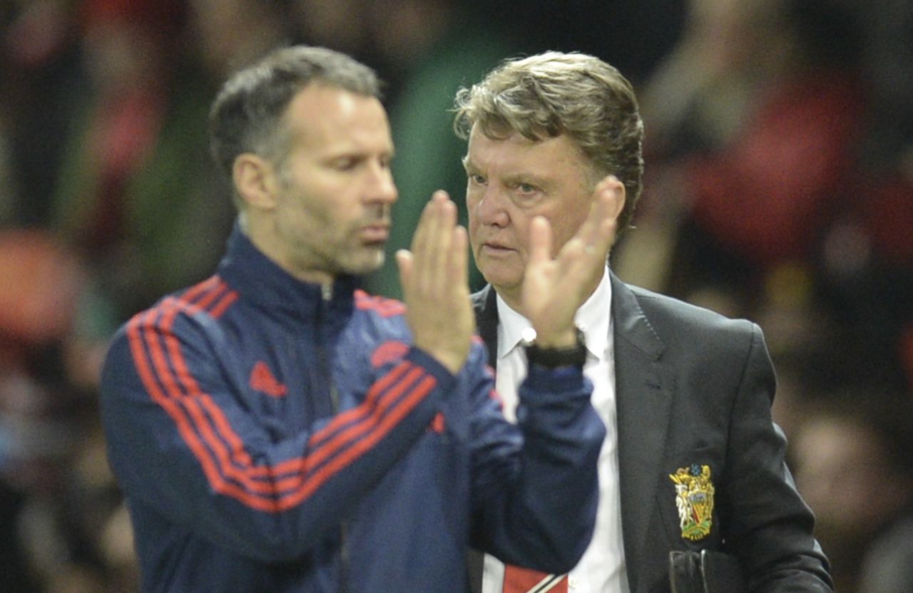 The draw ended a run of four defeats for United, easing some of the pressure on Dutch manager Louis van Gaal -- seen here right with his assistant Ryan Giggs (clapping). 