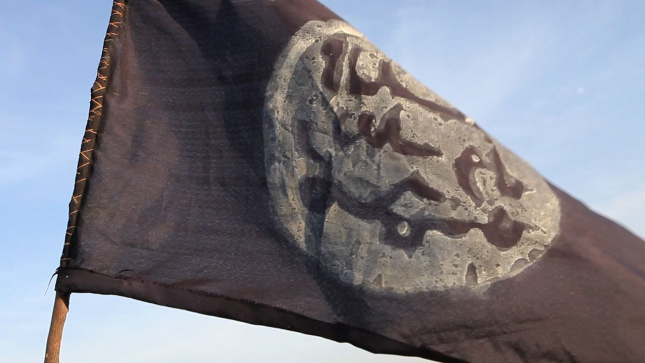 A Boko Haram flag flutters from an abandoned command post in Gamboru deserted after Chadian troops chased them from the border town on February 4, 2015. Nigerian Boko Haram fighters went on the rampage in the Cameroonian border town of Fotokol, massacring dozens of civilians and torching a mosque before being repelled by regional forces. AFP PHOTO/STEPHANE YAS        (Photo credit should read STEPHANE YAS/AFP/Getty Images)