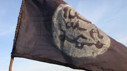 A Boko Haram flag flutters from an abandoned command post in Gamboru.