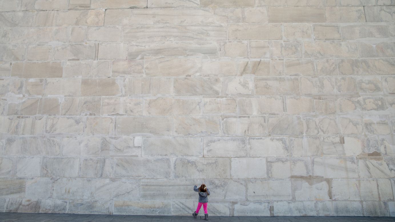 Photos of the U.S. capital's Washington Monument sometimes fail to capture the scale of the obelisk which opened to the public 127 years ago. This young girl, photographed at the foot of the 169-meter (555 foot), structure, gives some sense its size.