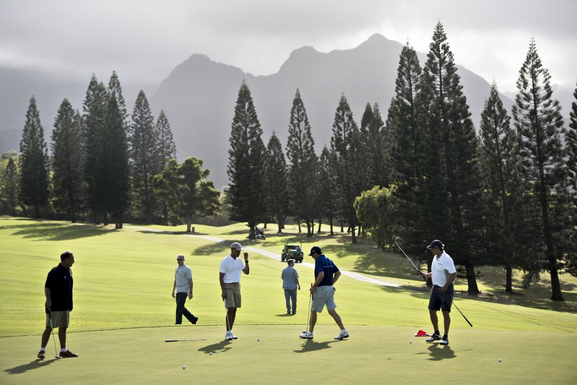 Obama golfs with longtime friends and former schoolmates from Hawaii: Bobby Titcomb, from left, Obama, Mike Ramos and Greg Orme walk on the 18th green. Secret Service agents are in the background.