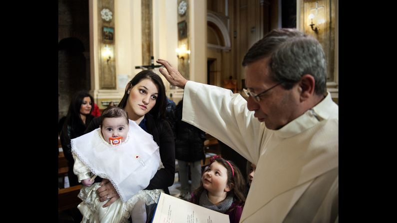 Carla has her daughter, Carmen, baptized.