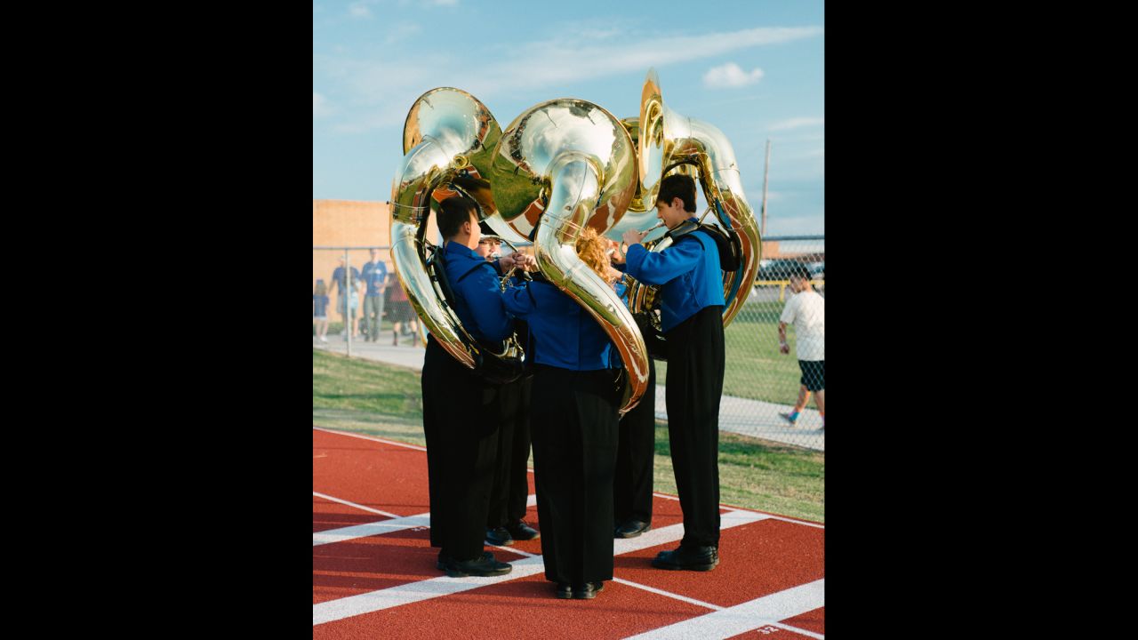 Sousaphone players in the Barbers Hill High School Marching Band circle up before a game.