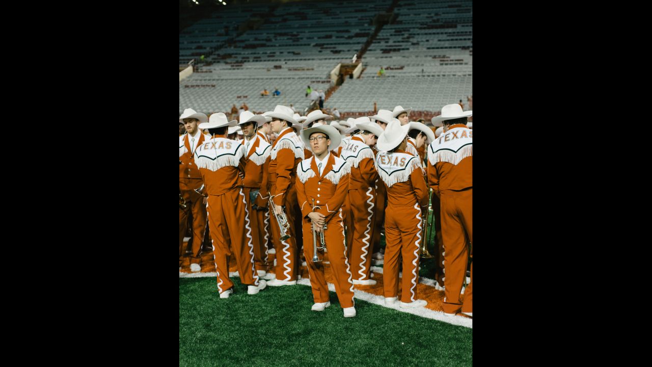 Bin Her poses with his trumpet before performing with The University of Texas Longhorn Band.