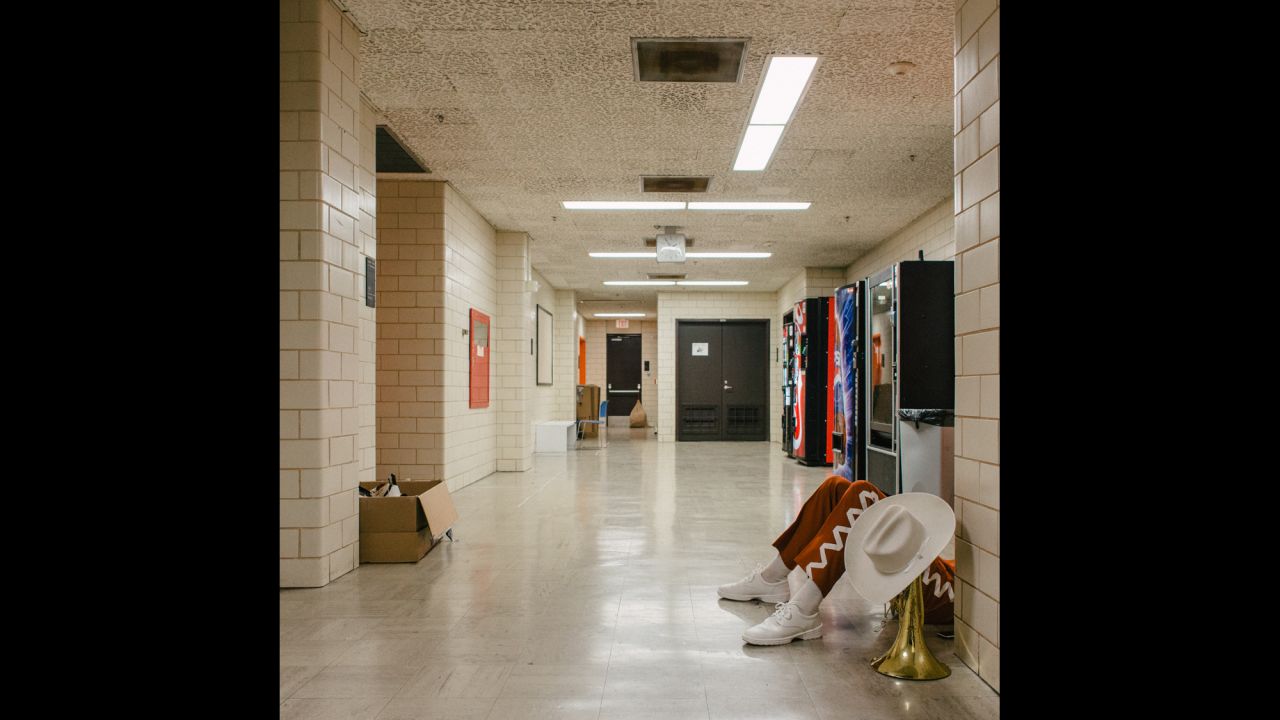 A Longhorn band member has a quiet moment before performing at a University of Texas-Oklahoma State game.
