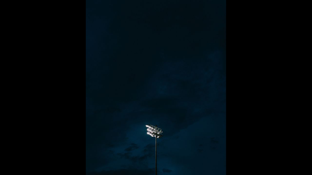 Stadium lights shine above the field at Round Rock High School's Dragon Stadium.