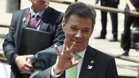 Colombian president Juan Manuel Santos gestures as he leaves the European Council on June 11, 2015, in Brussels.