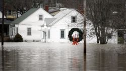 A holiday wreath hangs from a light post surrounded by floodwater from the Bourbeuse River, Tuesday, Dec. 29, 2015, in Union, Mo. Flooding across Missouri has forced the closure of hundreds of roads and threatened homes. (AP Photo/Jeff Roberson)