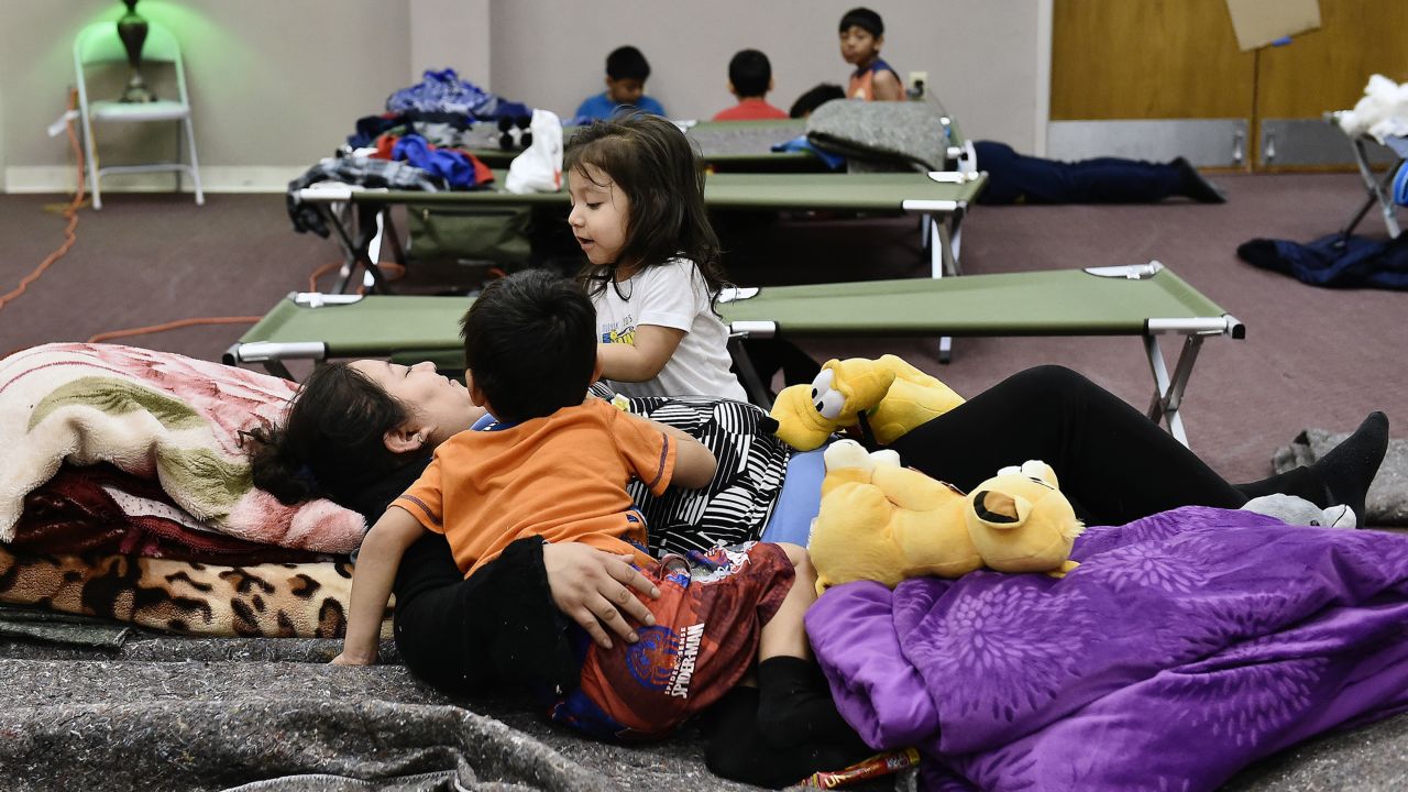 A family displaced by flooding passes time on December 29 at Fairview Christian Church in Carthage, Missouri, where the Red Cross set up a shelter.