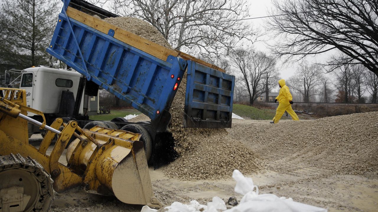 A load of gravel is dumped in an effort to hold back rising floodwaters in Kimmswick on December 28.