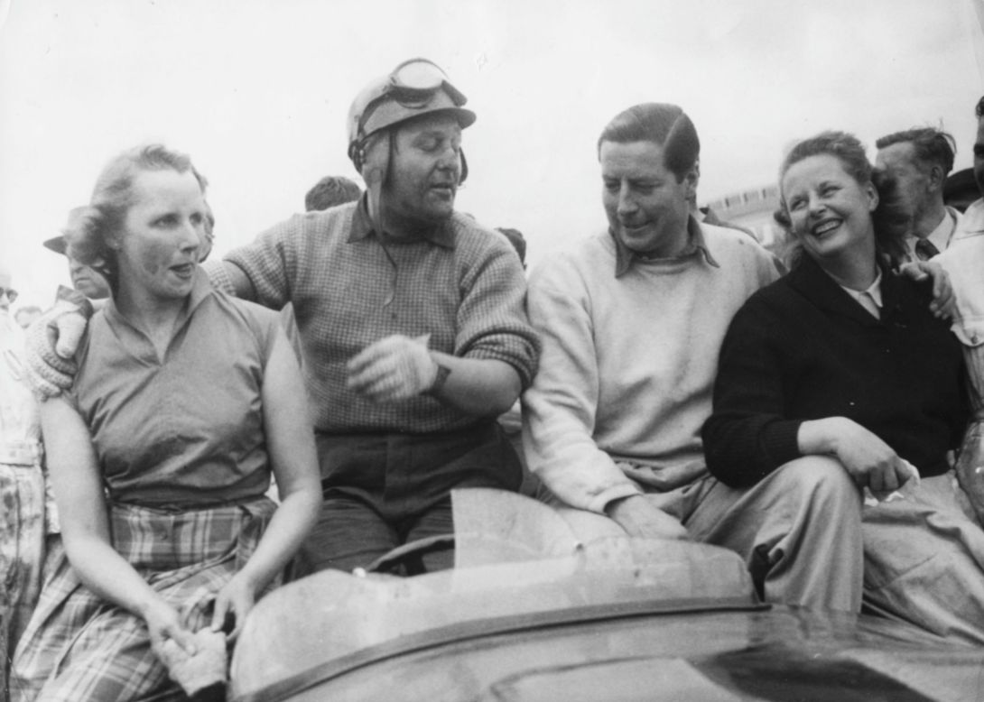 Jaguar's C-types are a force to be reckoned with at the Le Mans 24-hour endurance race. Major Tony Rolt (left) and Duncan Hamilton (right) celebrate with their wives after winning the title in 1953.