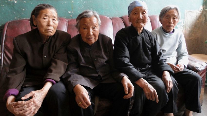 Four surviving former 'comfort women', women used as sex slaves by the Japanese military, sitting together.
