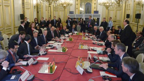 U.S. Secretary of State John Kerry meets with French Foreign Minister Laurent Fabius (4th R) and other leaders--all male-- at the start of the ministerial meeting on Syria in Paris in December.