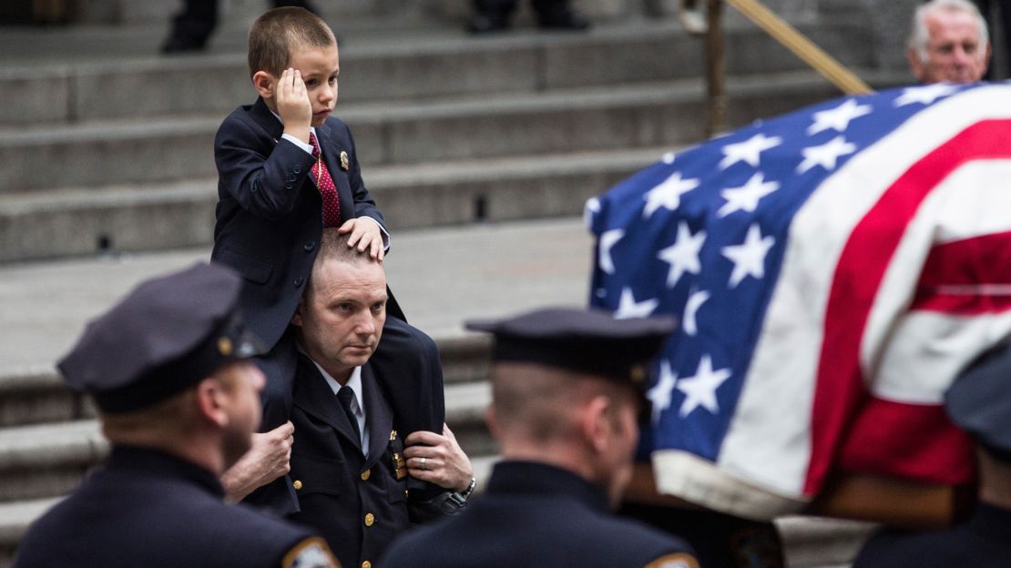 Joseph Lemm's son, Ryan, salutes at his father's funeral.