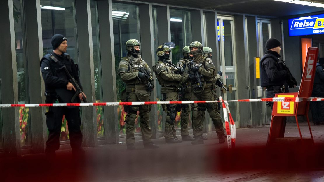 Police stand guard at a train station in Munich following threats of suicide bombings.