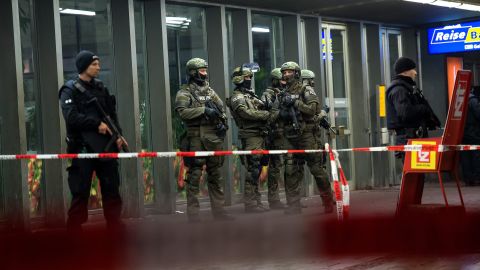 Police stand guard at a train station in Munich following threats of suicide bombings.