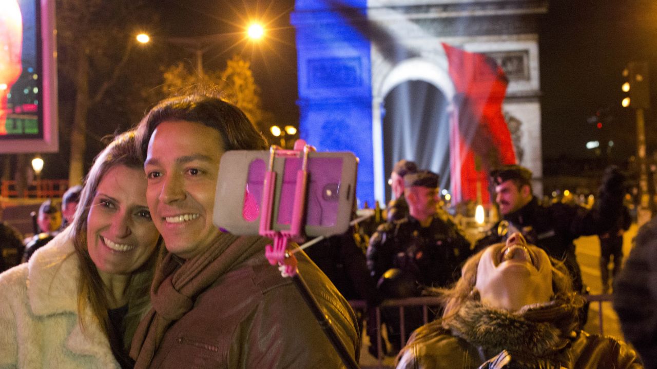 Party goers take selfies at the Arc de Triomphe during New Year's celebrations in Paris.