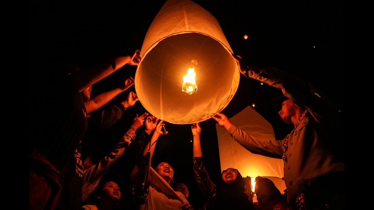 Indonesians release sky lanterns during the New Year celebrations in Magelang, Indonesia.