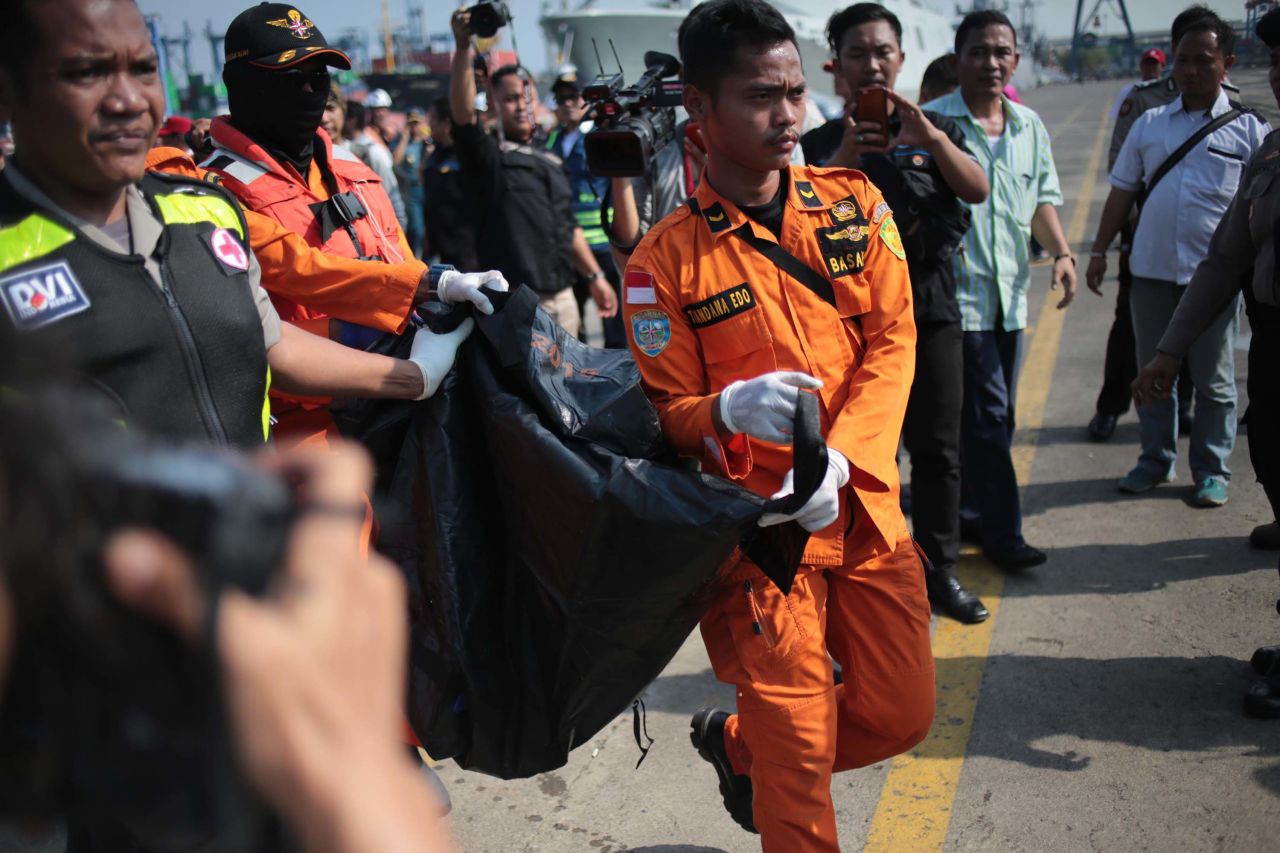 Members of a rescue team bring the bodies of victims ashore at the port in Tanjung Priok, North Jakarta, Indonesia.