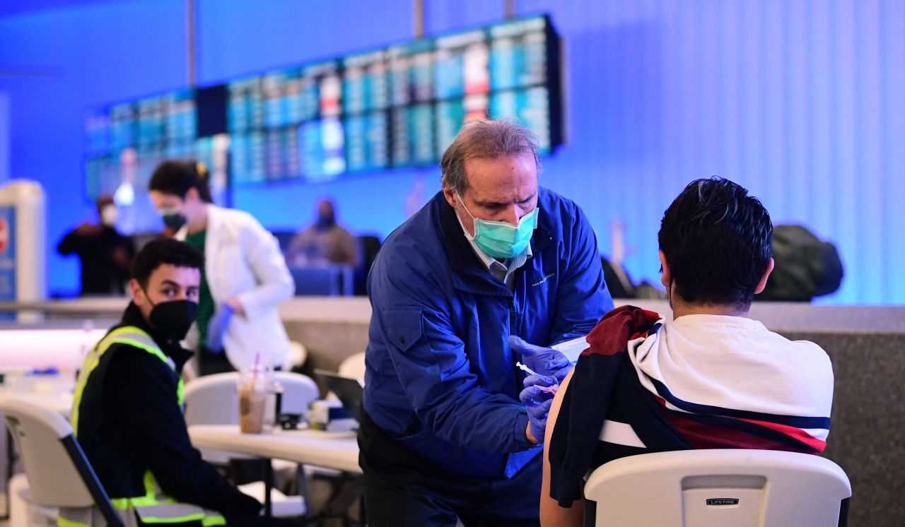 The Covid-19 vaccine is administered at a pop-up clinic in the international arrivals section of Los Angeles International Airport in Los Angeles, California on December 22, 2021.