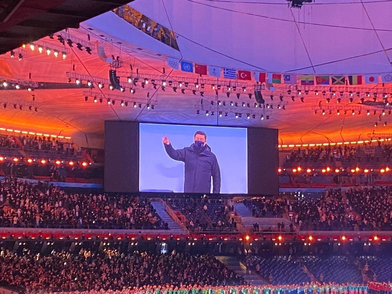 President XI waves to the crowd as he makes his way to his seat. 